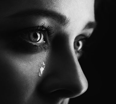 Closeup photo of a woman shedding a tear