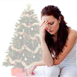 A woman with a migraine sits in front of a Christmas tree